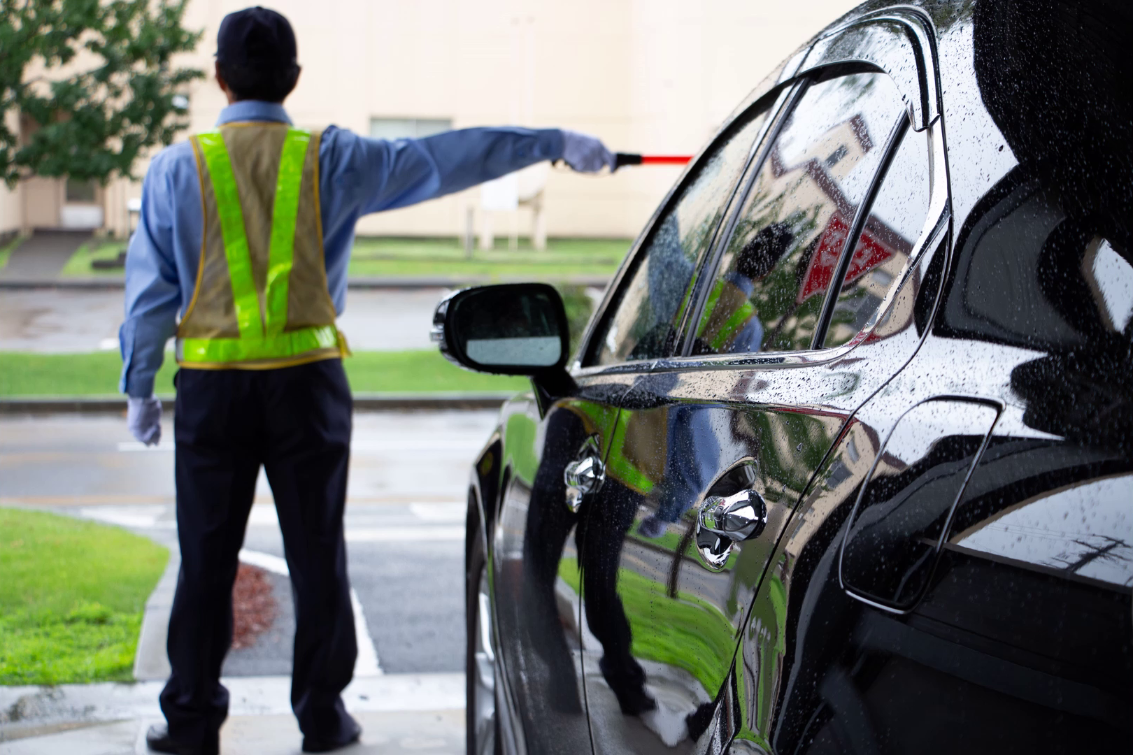Uniformed officer directing a vehicle outdoors