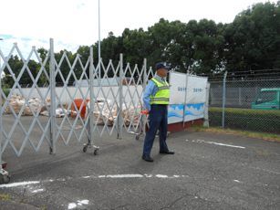 A Zone security officer at an expandable site entrance gate