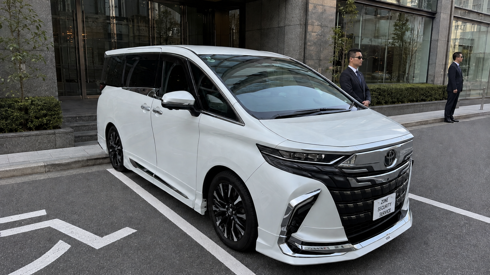 White Toyota van with security personnel outside a Tokyo office building